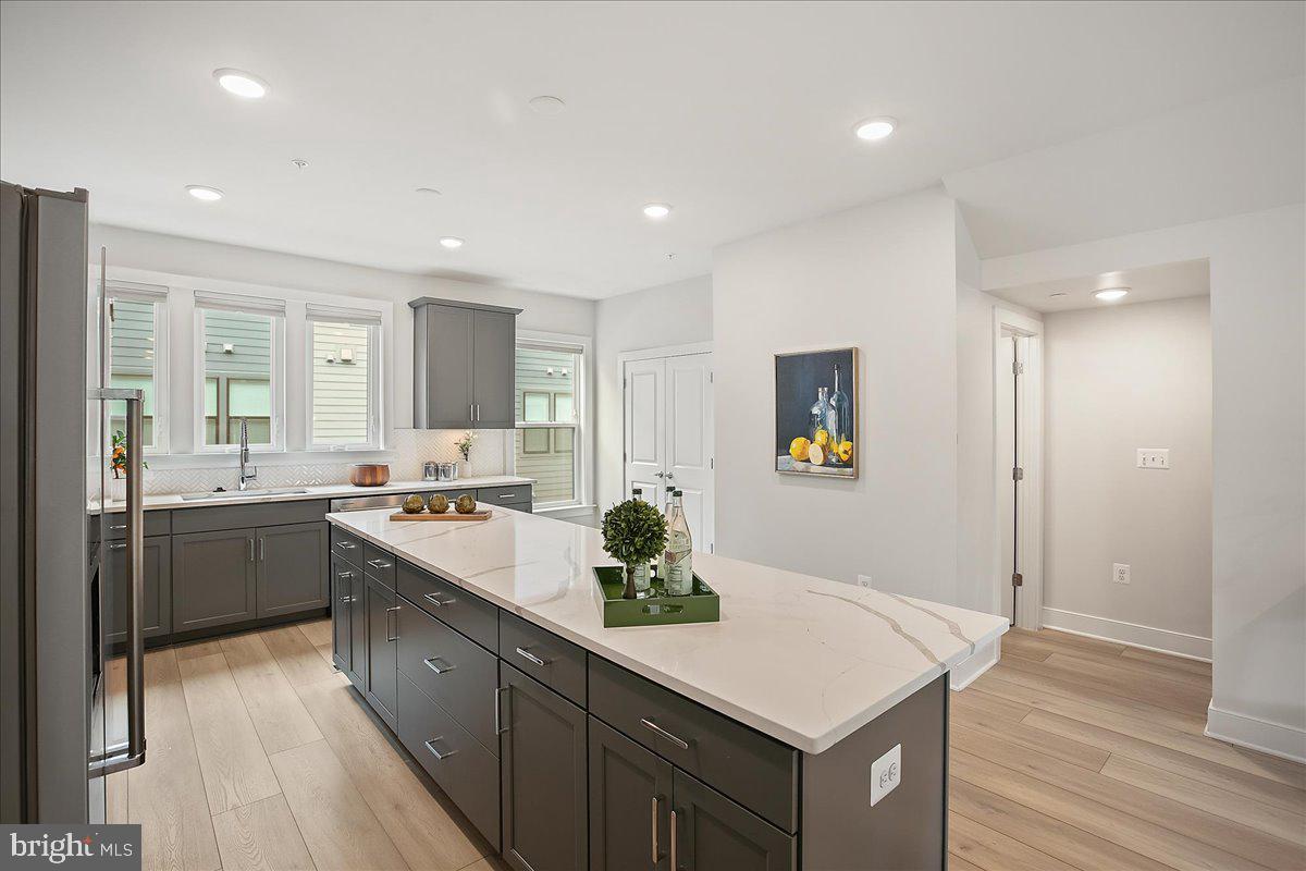 12768 Sunrise Valley Drive Reston, VA 20191 - Photo 3 of 33 a kitchen with a sink stove and refrigerator