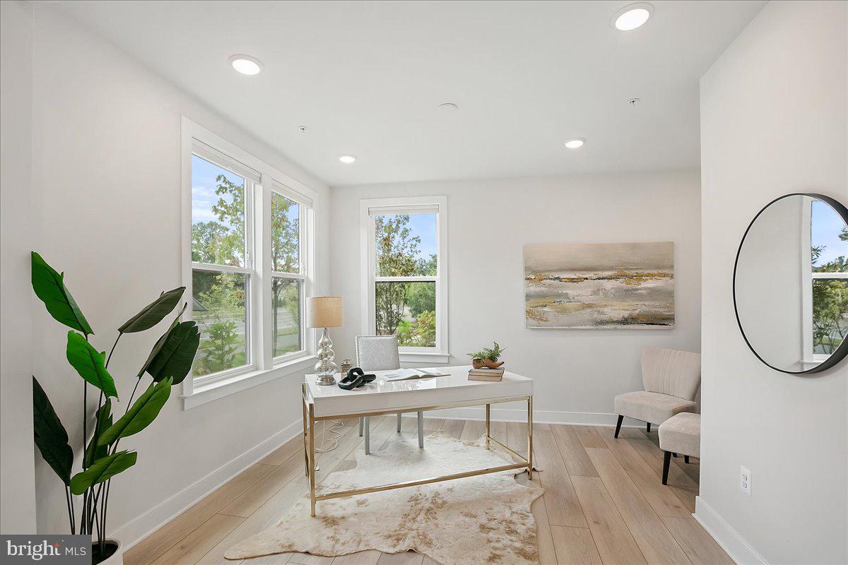 12768 Sunrise Valley Drive Reston, VA 20191 - Photo 6 of 33 a living room with furniture a large window and a potted plant
