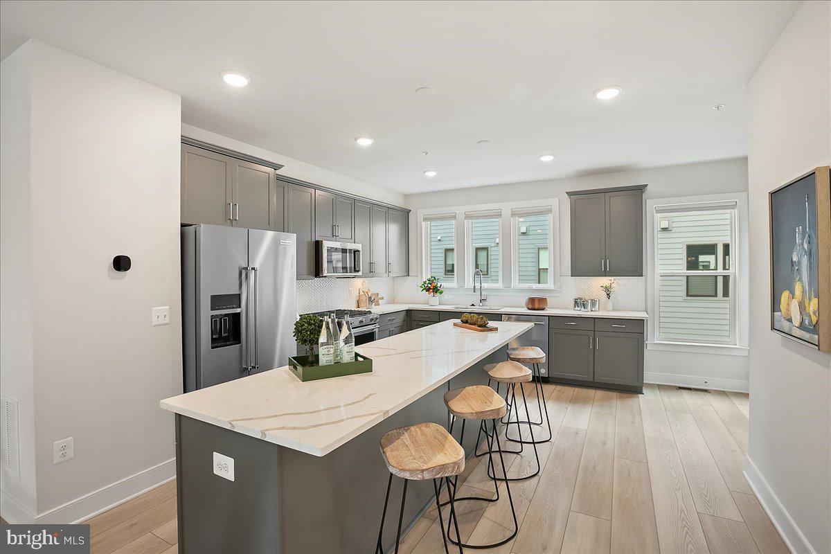 12768 Sunrise Valley Drive Reston, VA 20191 - Photo 8 of 33 a large kitchen with a table and chairs