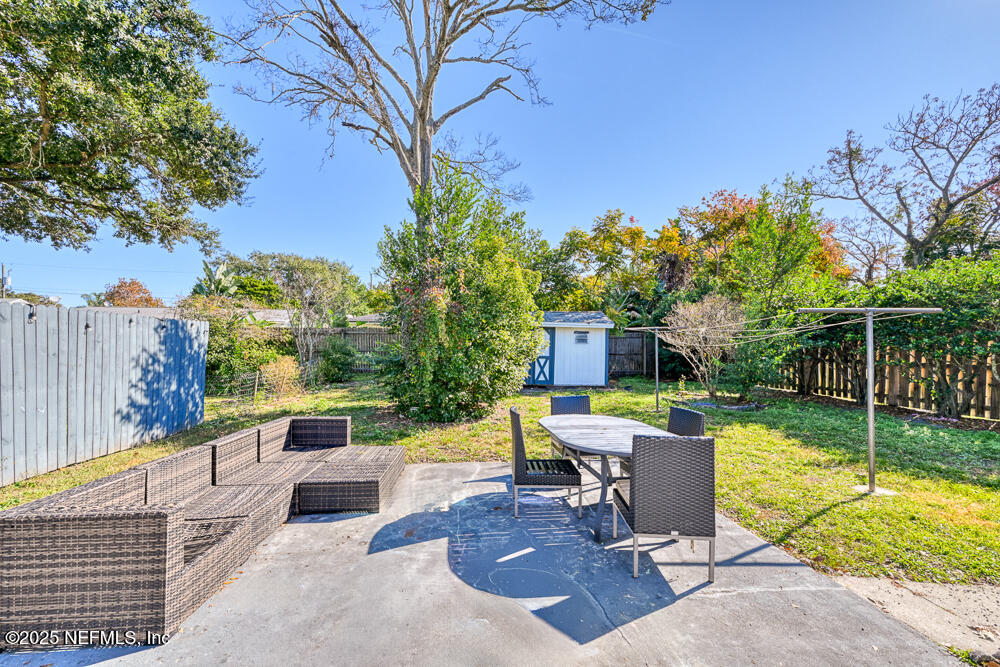 1907 Penman Road Jacksonville Beach, FL 32250 - Photo 14 of 27 a view of a chair and tables in the back yard of the house