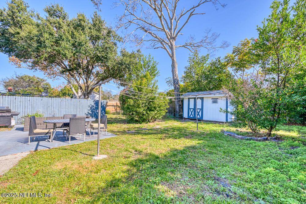 1907 Penman Road Jacksonville Beach, FL 32250 - Photo 15 of 27 a backyard of a house with table and chairs