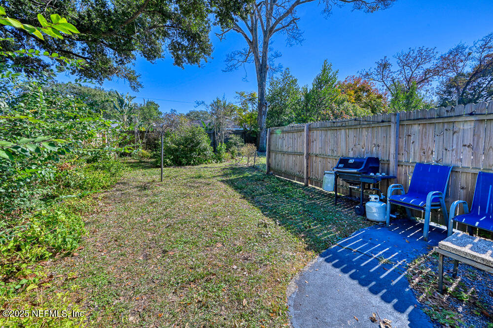 1907 Penman Road Jacksonville Beach, FL 32250 - Photo 23 of 27 a view of backyard with wooden fence and trees