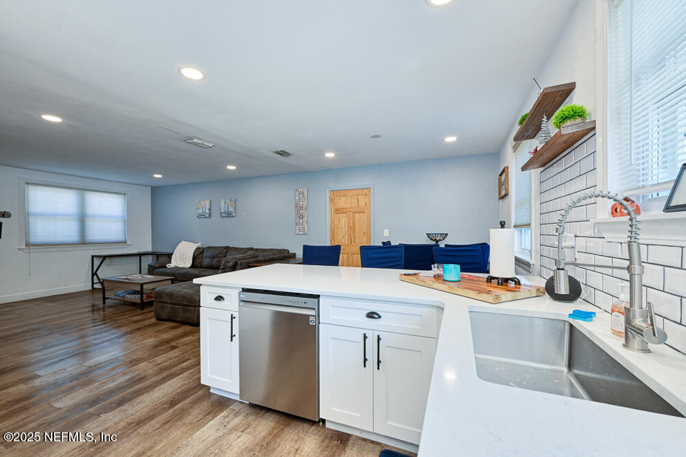 1907 Penman Road Jacksonville Beach, FL 32250 - Photo 7 of 27 a kitchen that has a lot of cabinets in it and wooden floor