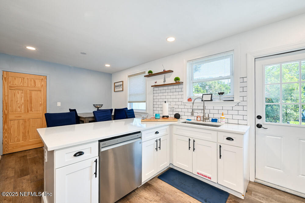 1907 Penman Road Jacksonville Beach, FL 32250 - Photo 8 of 27 a kitchen with a sink window and cabinets