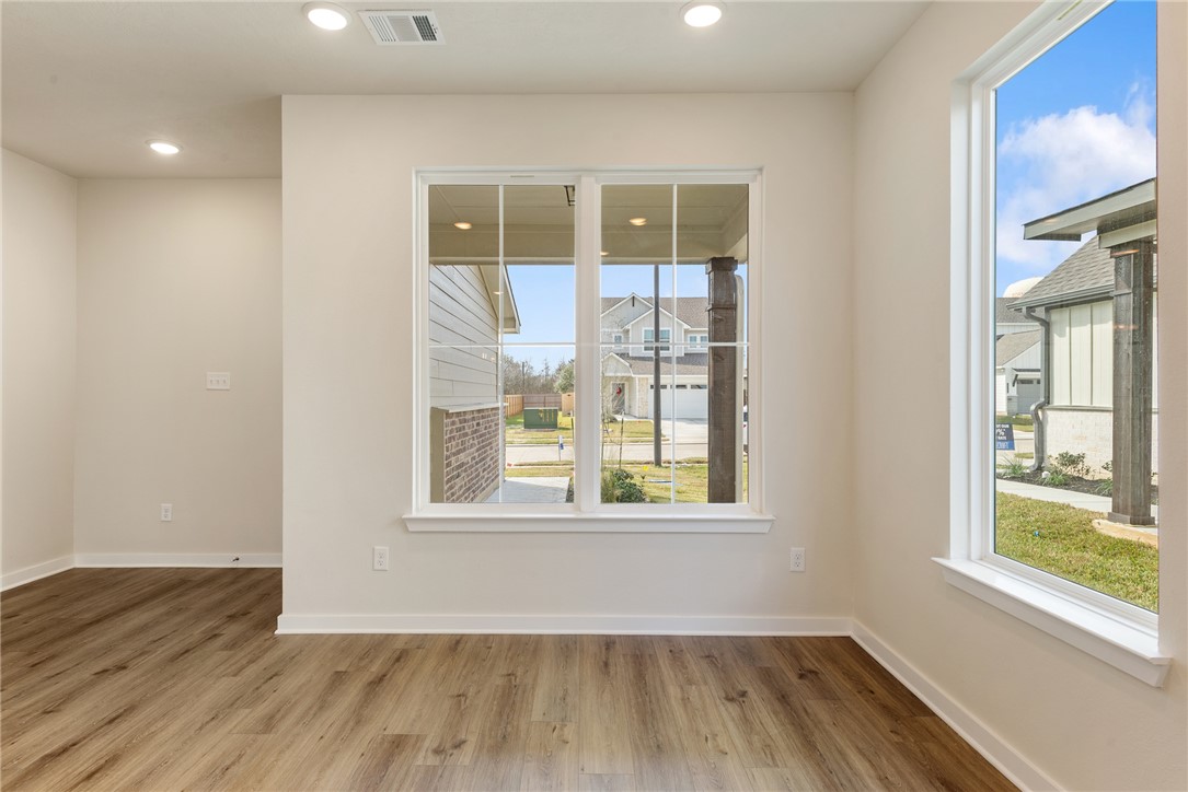 15238 Still Water Mdw Loop Bryan, TX 77845 - Photo 17 of 50 a view of an empty room with wooden floor and a window