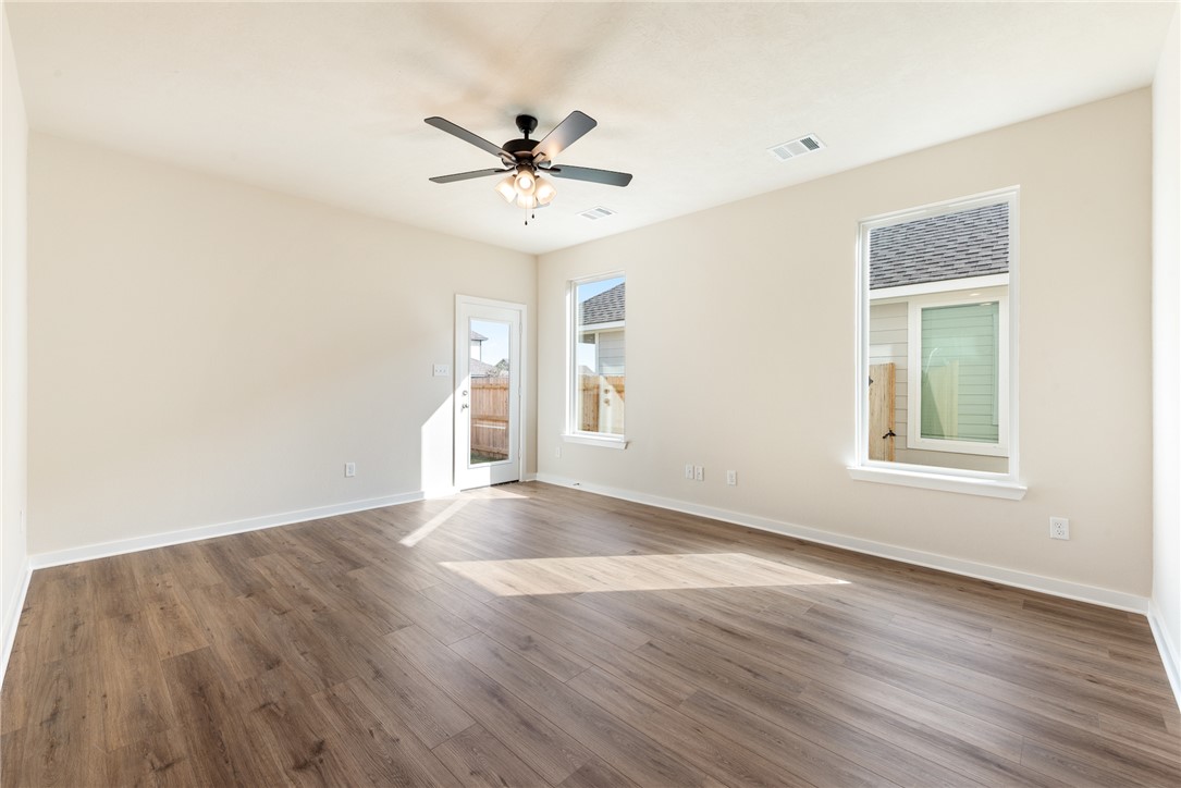 15238 Still Water Mdw Loop Bryan, TX 77845 - Photo 20 of 50 a view of an empty room with wooden floor and a window