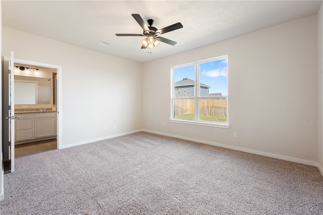 15238 Still Water Mdw Loop Bryan, TX 77845 - Photo 25 of 50 an empty room with a window and a ceiling fan