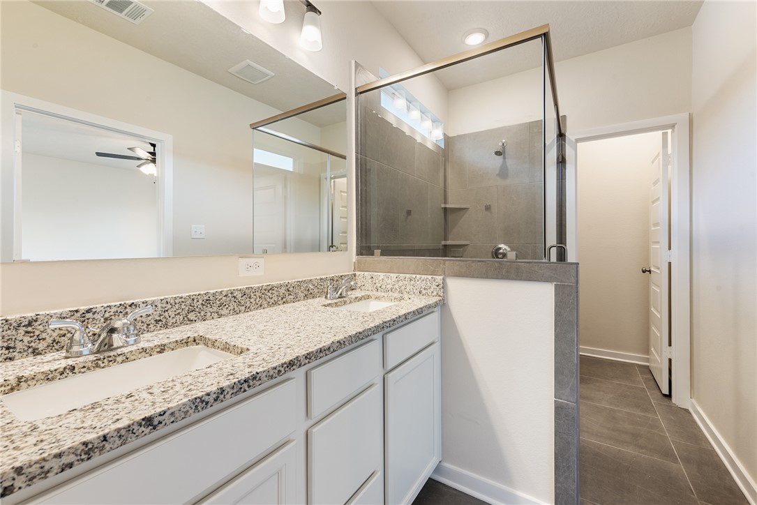 15238 Still Water Mdw Loop Bryan, TX 77845 - Photo 30 of 50 a bathroom with a sink and a mirror
