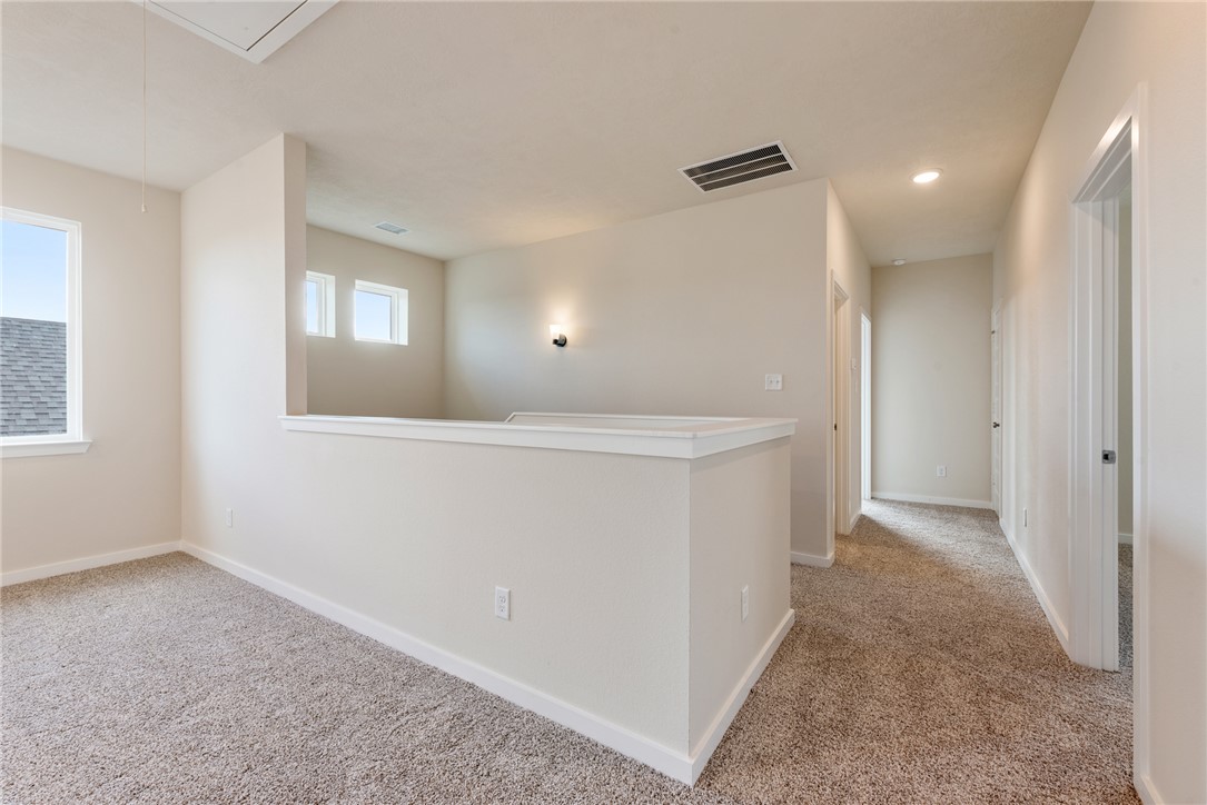 15238 Still Water Mdw Loop Bryan, TX 77845 - Photo 34 of 50 a view of an empty room with window and wooden floor