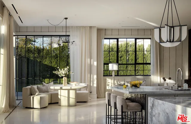 a living room with furniture and kitchen view