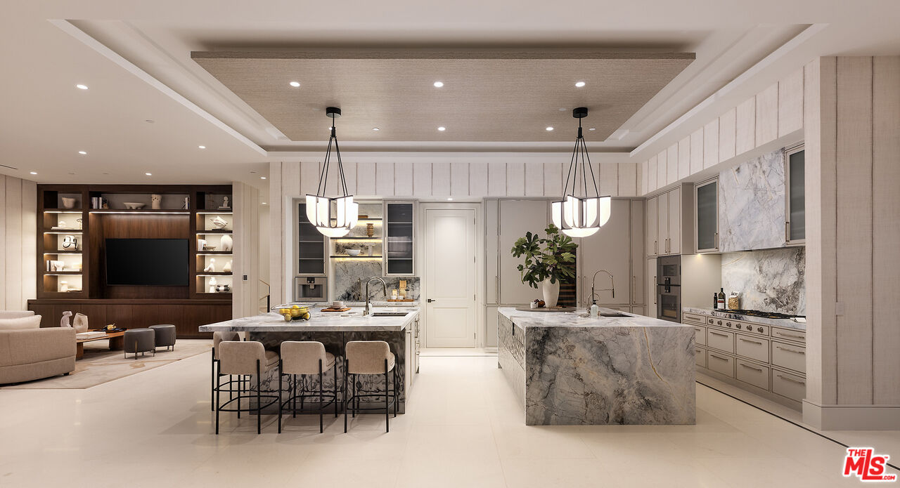 721 North Bonhill Road Los Angeles, CA 90049 - Photo 20 of 64 a kitchen with stainless steel appliances kitchen island granite countertop a table and chairs