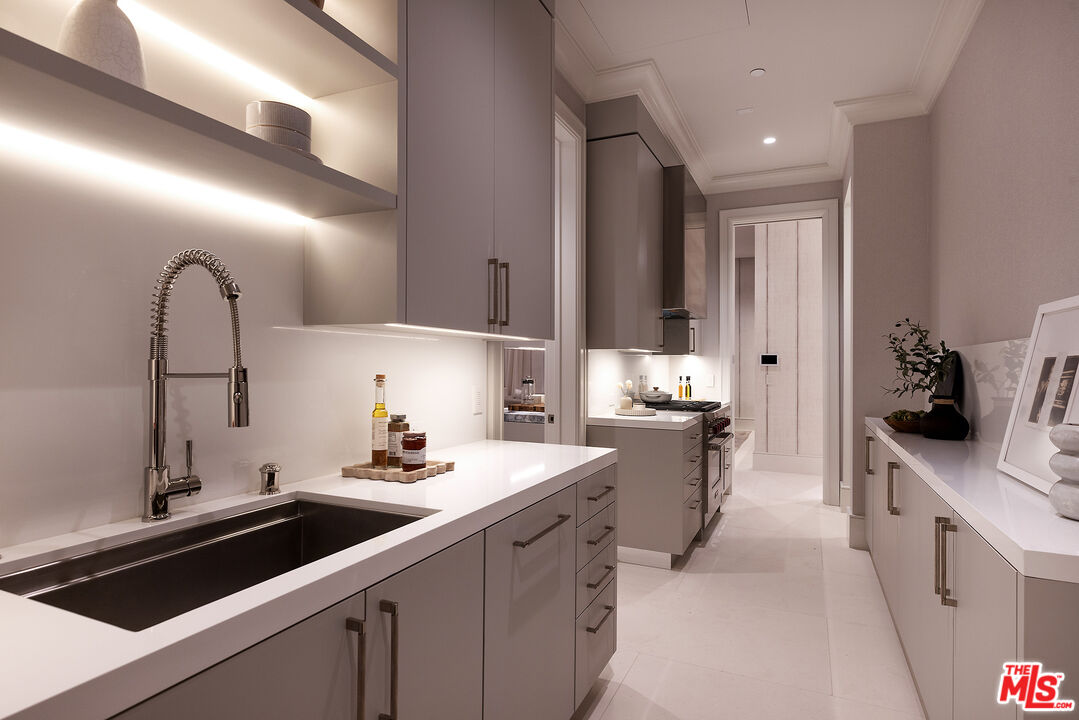721 North Bonhill Road Los Angeles, CA 90049 - Photo 21 of 64 a kitchen with a sink stove and cabinets
