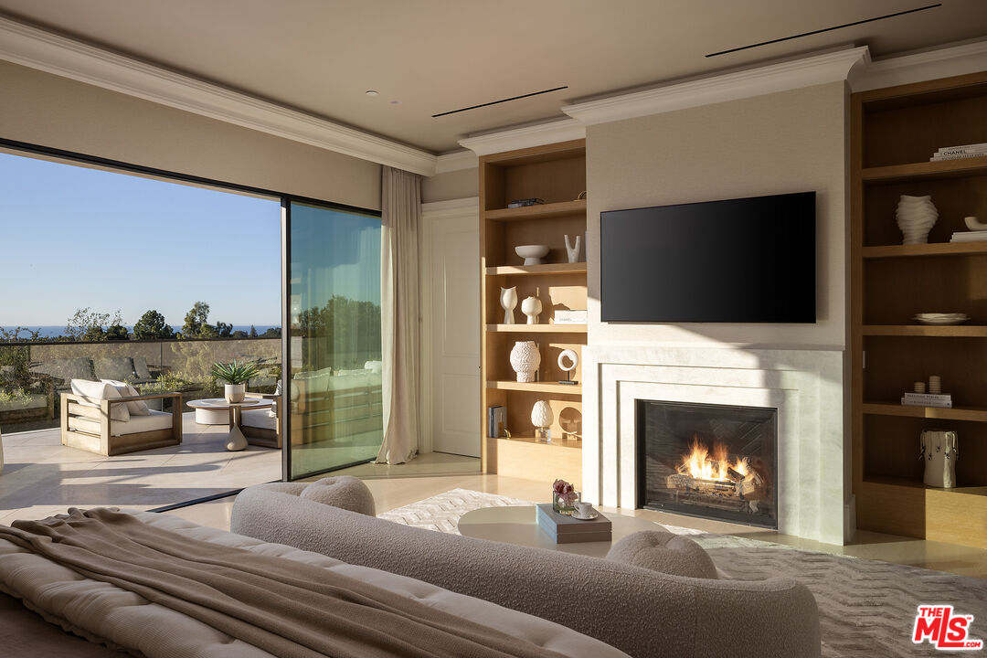 721 North Bonhill Road Los Angeles, CA 90049 - Photo 25 of 64 a living room with furniture a fireplace and a flat screen tv