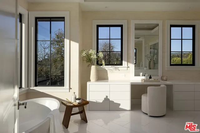 a bathroom with a granite countertop sink a mirror and a shower