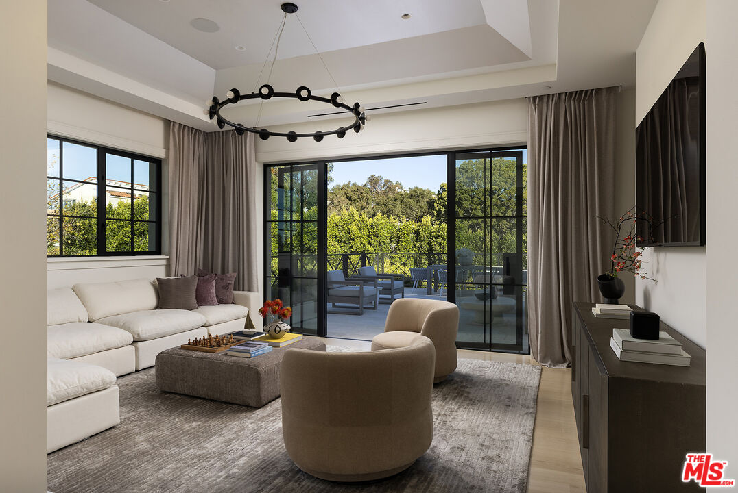 721 North Bonhill Road Los Angeles, CA 90049 - Photo 38 of 64 a living room with furniture and a flat screen tv