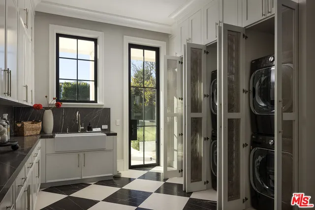 a bathroom with a double vanity sink and a window