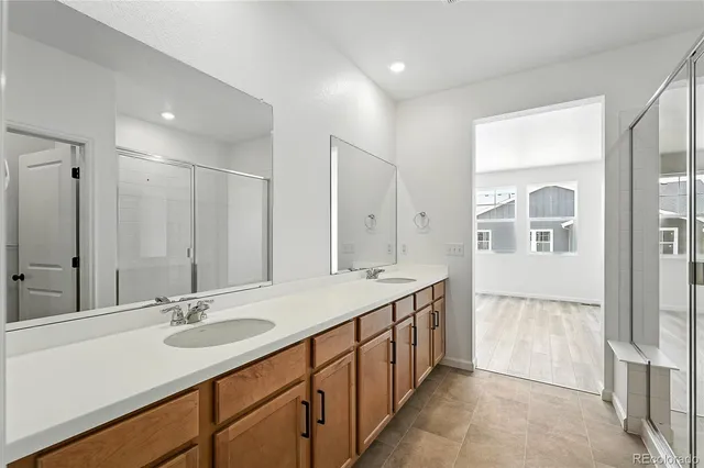 a bathroom with a double vanity sink and a mirror
