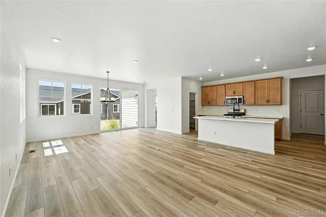 a view of large kitchen with granite countertop cabinets and wooden floor