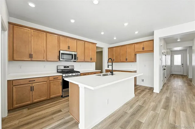 a kitchen with a sink stove and refrigerator