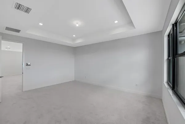 a view of an empty room and a window
