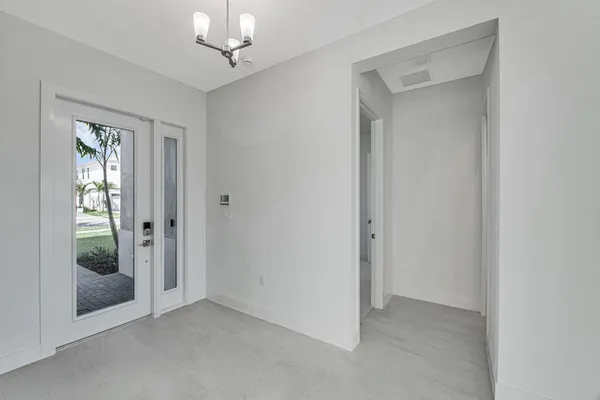 a large kitchen with stainless steel appliances granite countertop a refrigerator and a sink