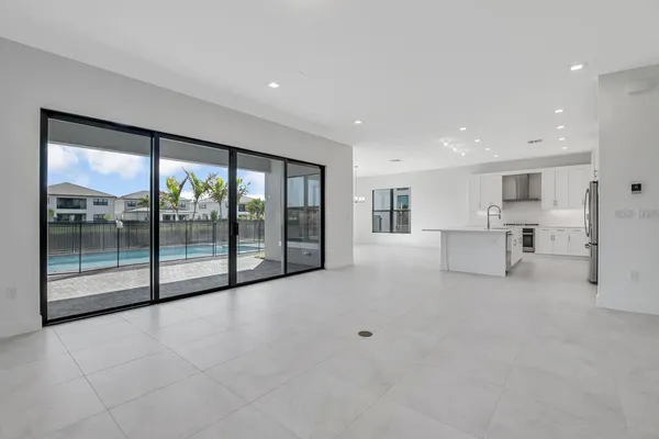 a kitchen with stainless steel appliances white cabinets and a refrigerator
