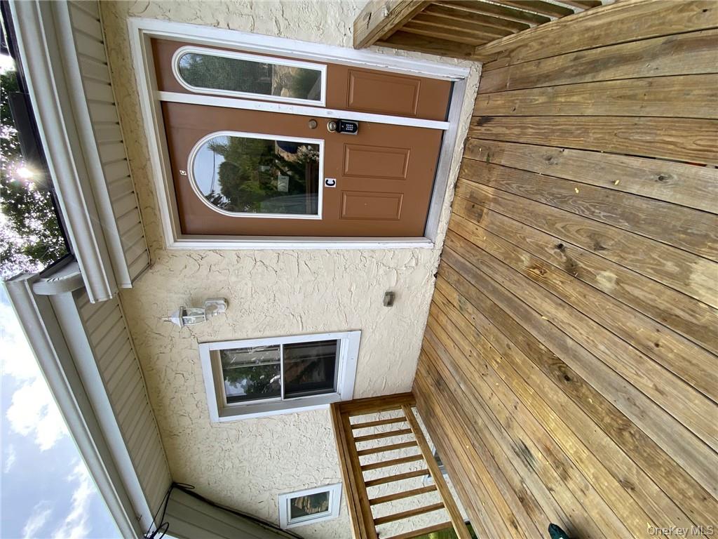 49 Croton Point Avenue, Unit C Croton-on-Hudson, NY 10520 - Photo 12 of 17 a view of a house with porch and wooden floor