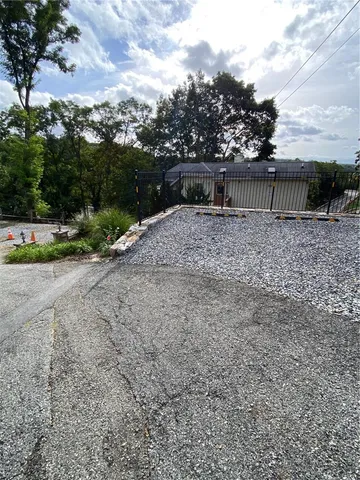 a view of a balcony with wooden floor and fence