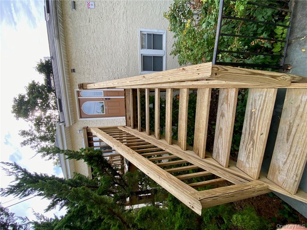 49 Croton Point Avenue, Unit C Croton-on-Hudson, NY 10520 - Photo 14 of 17 a view of a balcony with wooden floor and fence
