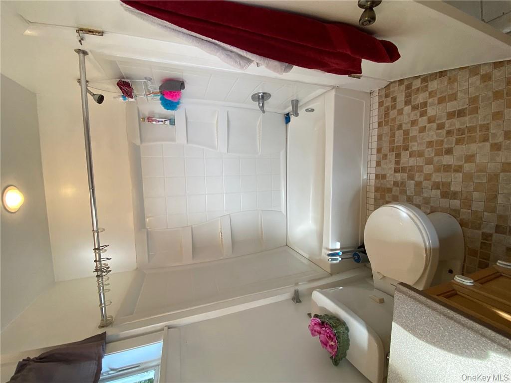 49 Croton Point Avenue, Unit C Croton-on-Hudson, NY 10520 - Photo 15 of 17 a bathroom with a toilet and a shower