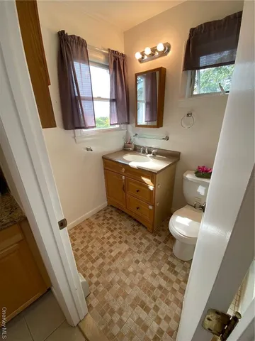 an empty room with a ceiling fan and windows