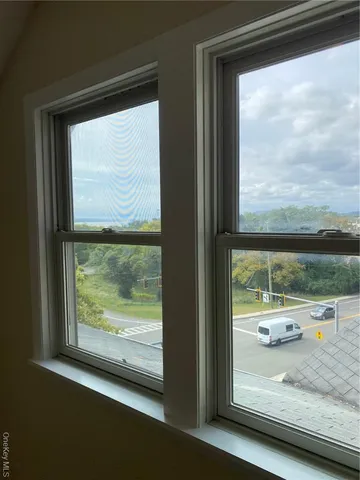 a view of a backyard with chairs and plants