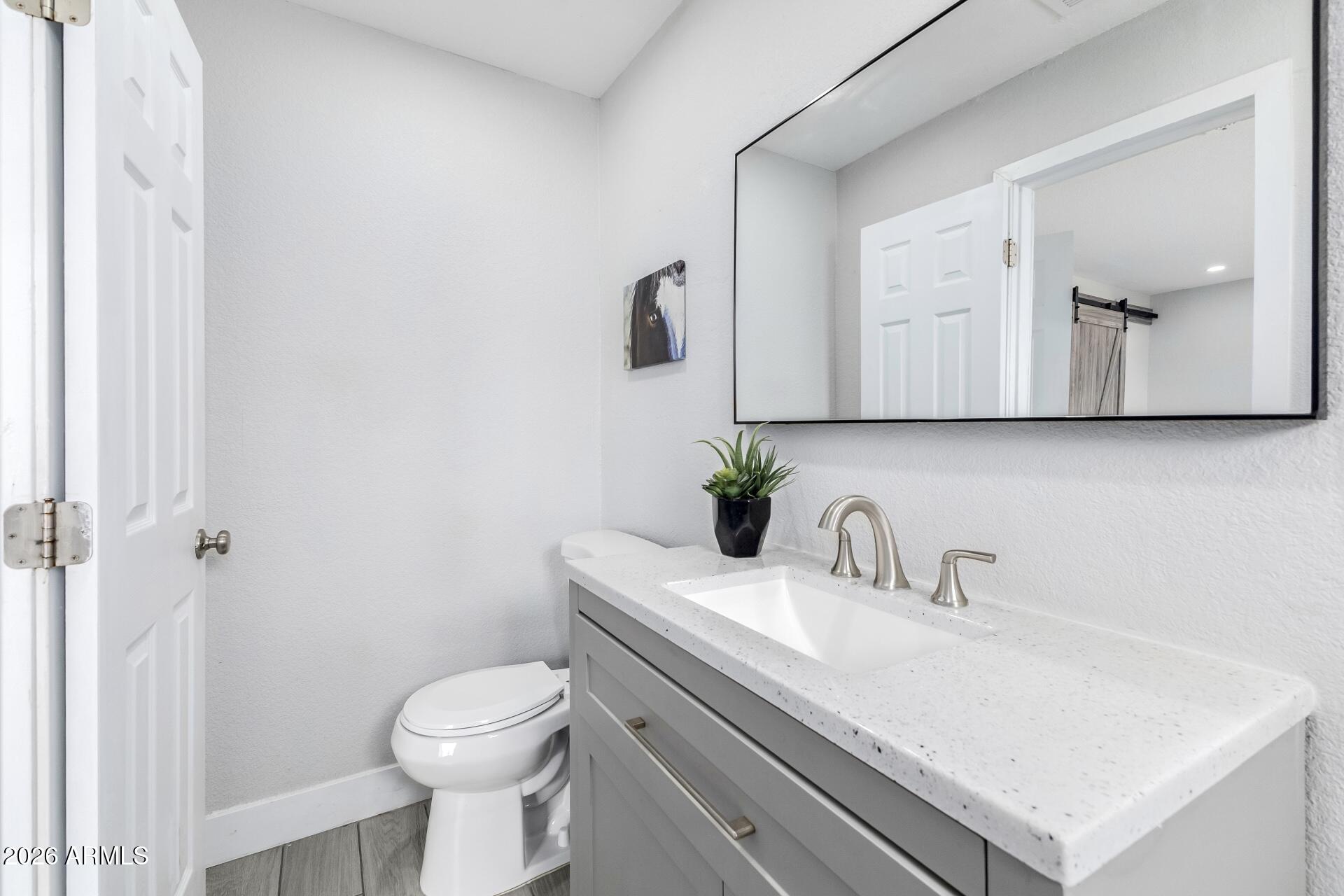 17428 North 20th Street Phoenix, AZ 85022 - Photo 12 of 24 a bathroom with a sink toilet and mirror