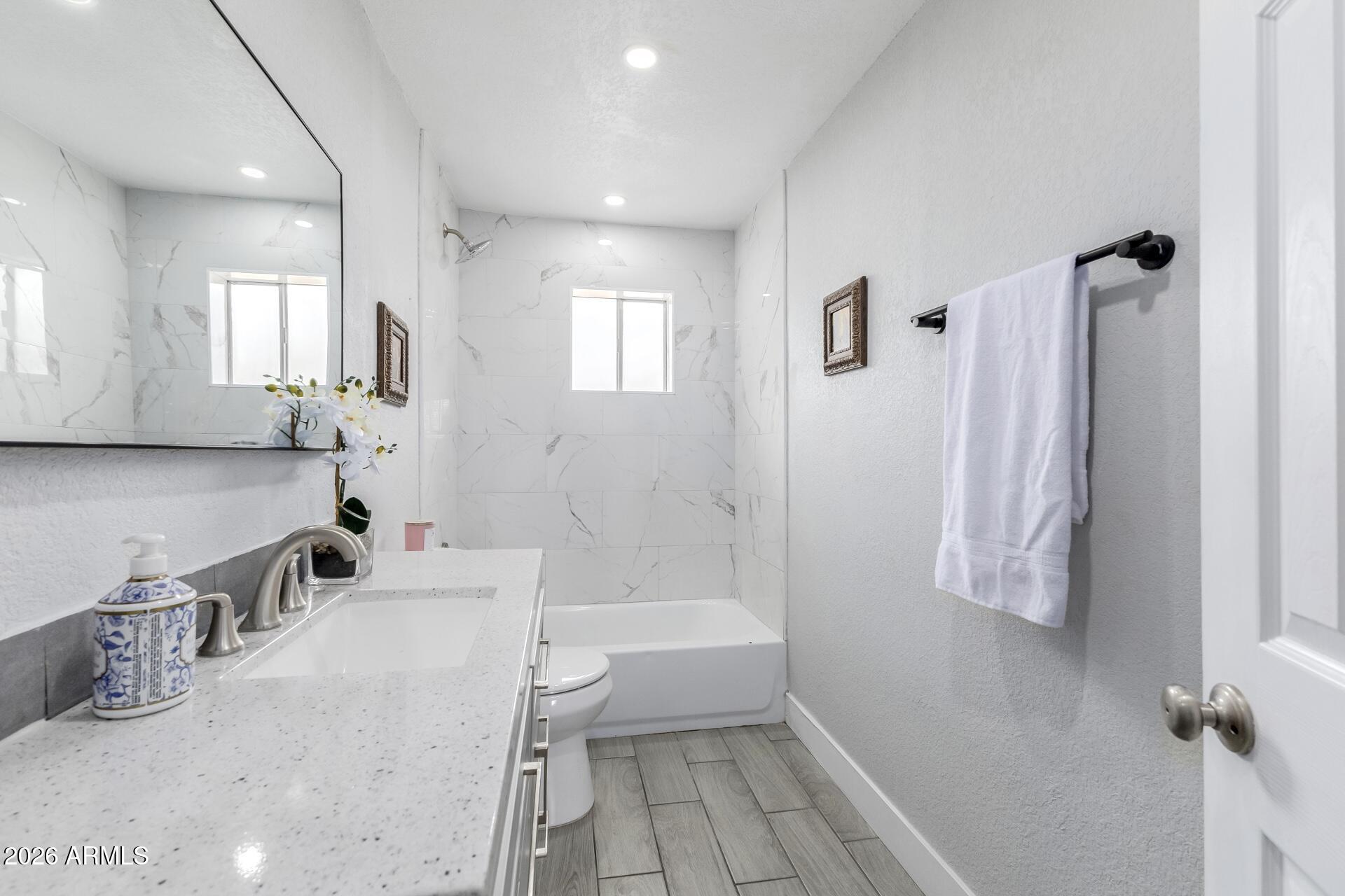 17428 North 20th Street Phoenix, AZ 85022 - Photo 16 of 24 a bathroom with a sink a toilet and shower