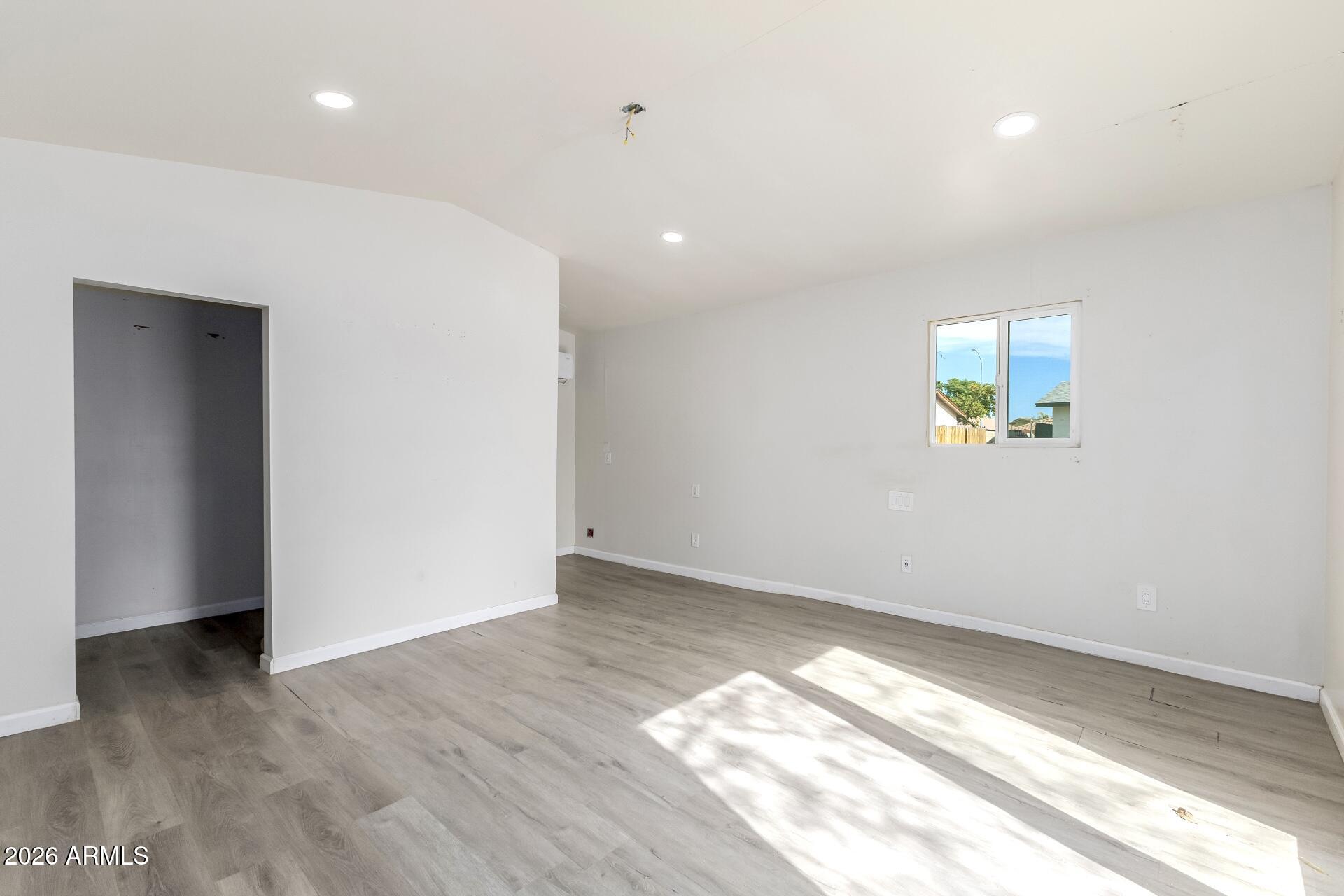 17428 North 20th Street Phoenix, AZ 85022 - Photo 22 of 24 an empty room with wooden floor and windows