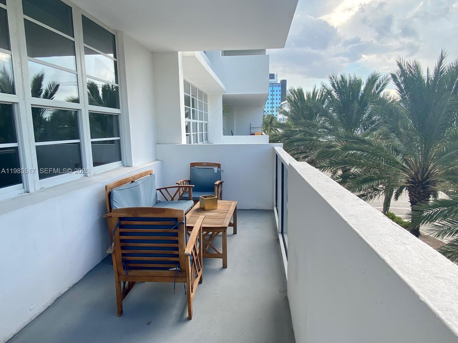 100 Lincoln Road, Unit 308 Miami Beach, FL 33139 - Photo 11 of 11 a balcony with chairs and a table