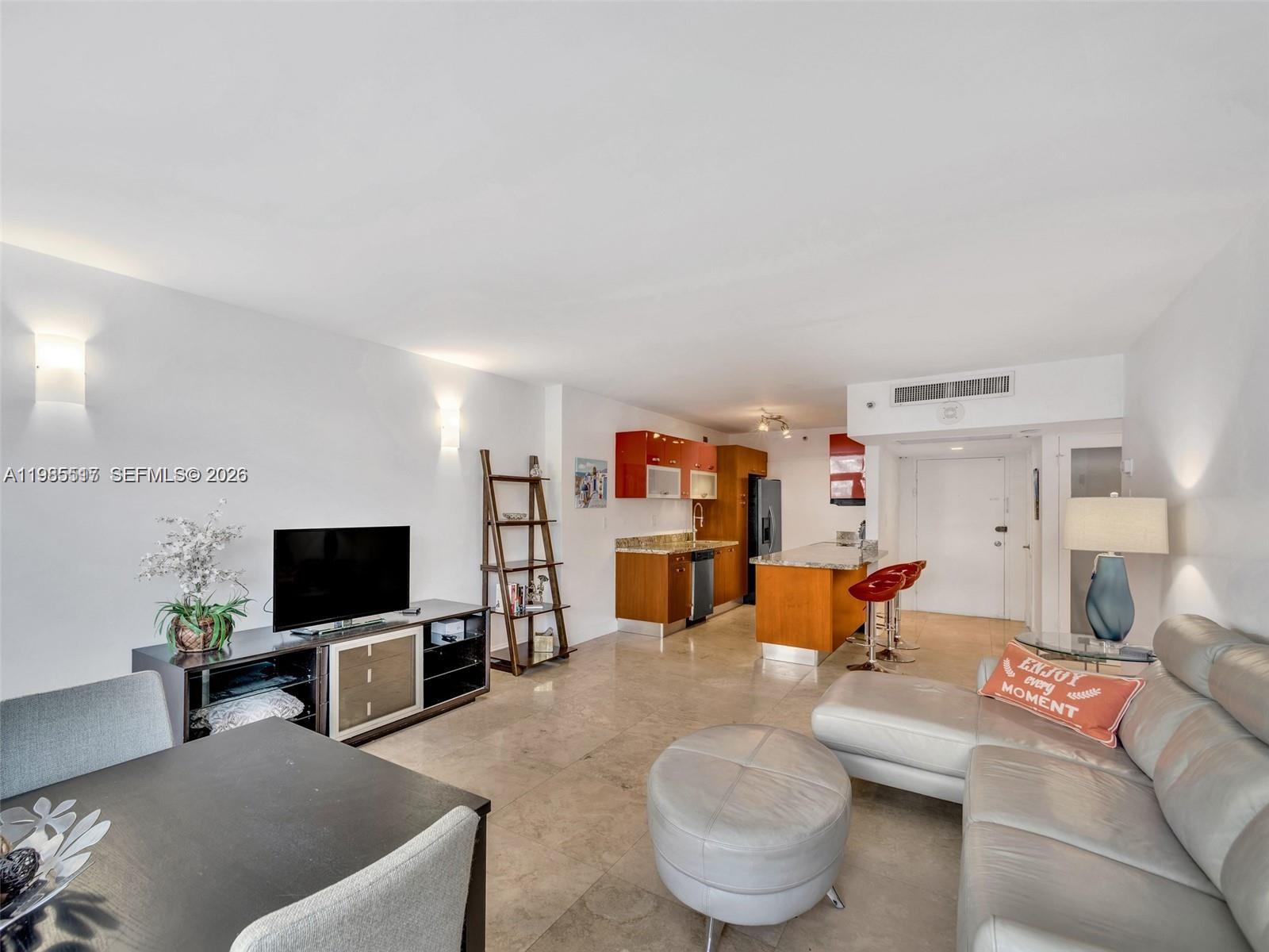 100 Lincoln Road, Unit 308 Miami Beach, FL 33139 - Photo 2 of 11 a living room with furniture and a flat screen tv