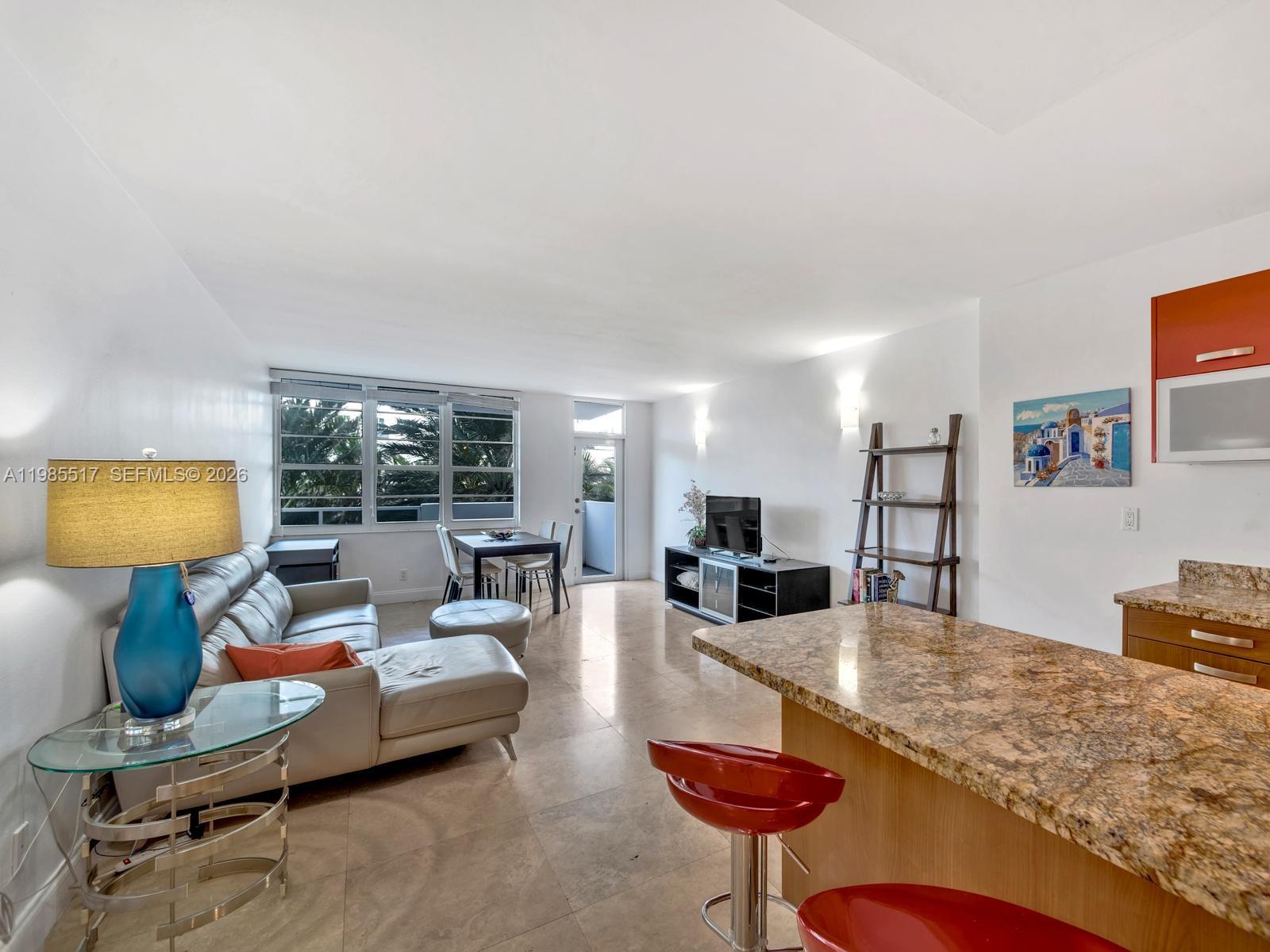 100 Lincoln Road, Unit 308 Miami Beach, FL 33139 - Photo 3 of 11 a living room with furniture and a flat screen tv