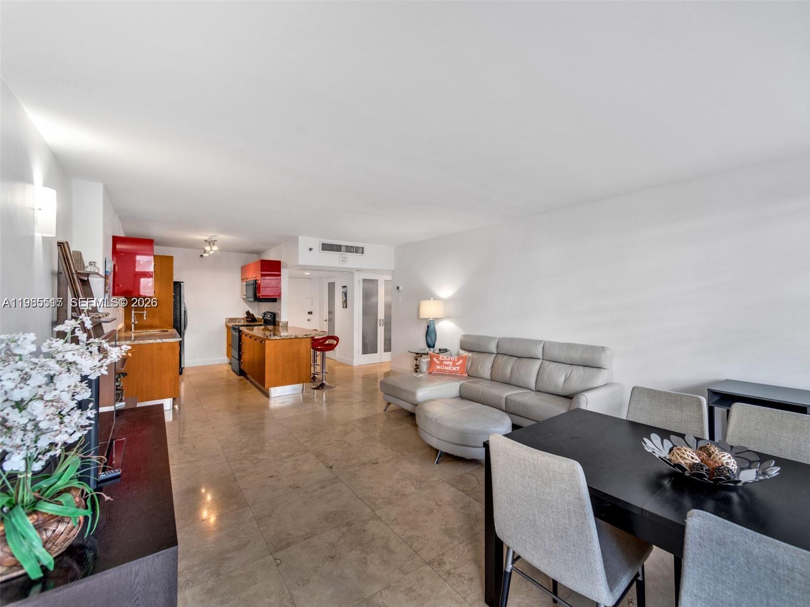 100 Lincoln Road, Unit 308 Miami Beach, FL 33139 - Photo 4 of 11 a living room with furniture and a flat screen tv