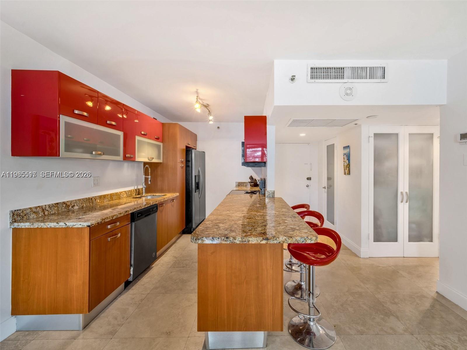 100 Lincoln Road, Unit 308 Miami Beach, FL 33139 - Photo 6 of 11 a kitchen with stainless steel appliances granite countertop a sink and refrigerator