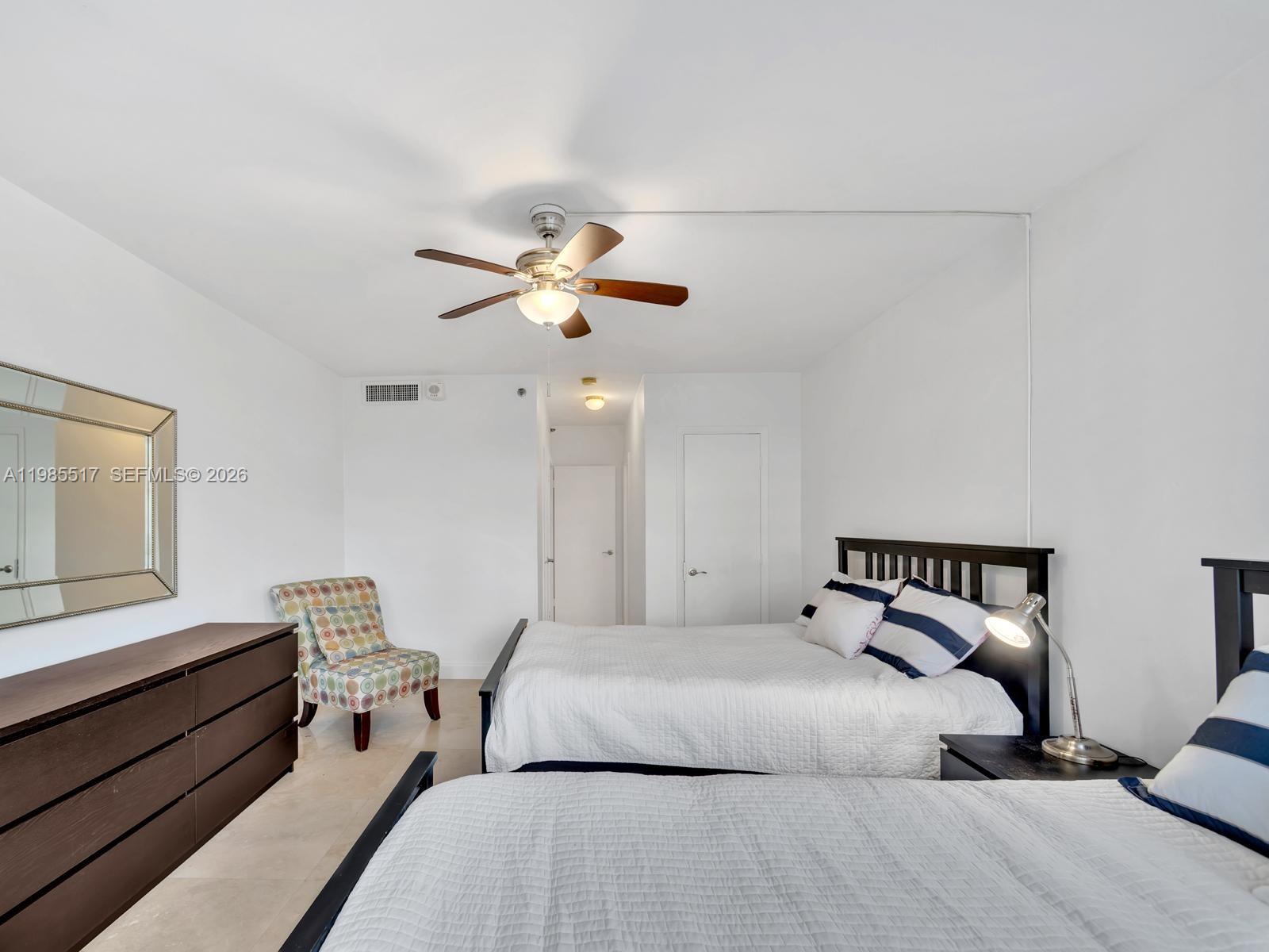 100 Lincoln Road, Unit 308 Miami Beach, FL 33139 - Photo 9 of 11 a bedroom with a bed and a chandelier