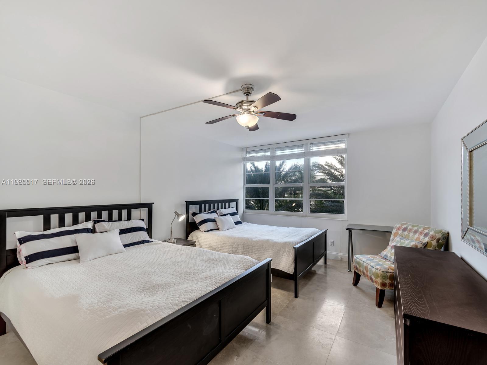 100 Lincoln Road, Unit 308 Miami Beach, FL 33139 - Photo 10 of 11 a bedroom with a bed and a large window
