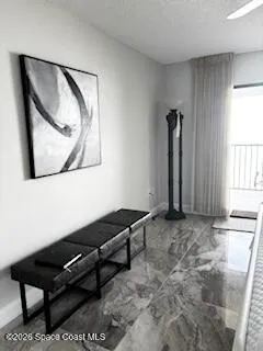 a view of a workspace with furniture and a window