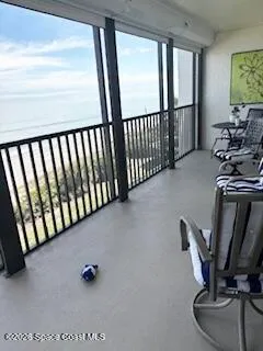 a balcony view with a couch and chairs