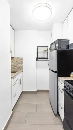 a kitchen with a refrigerator stove and microwave