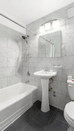 a bathroom view mirror a toilet and bathtub
