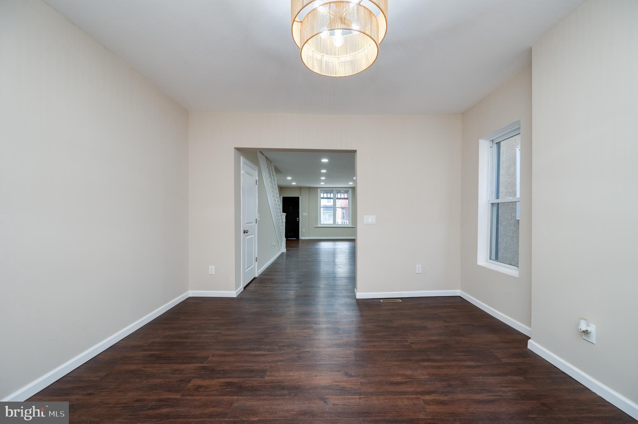 137 Elm Street Reading, PA 19601 - Photo 13 of 49 a view of an empty room with wooden floor and a window