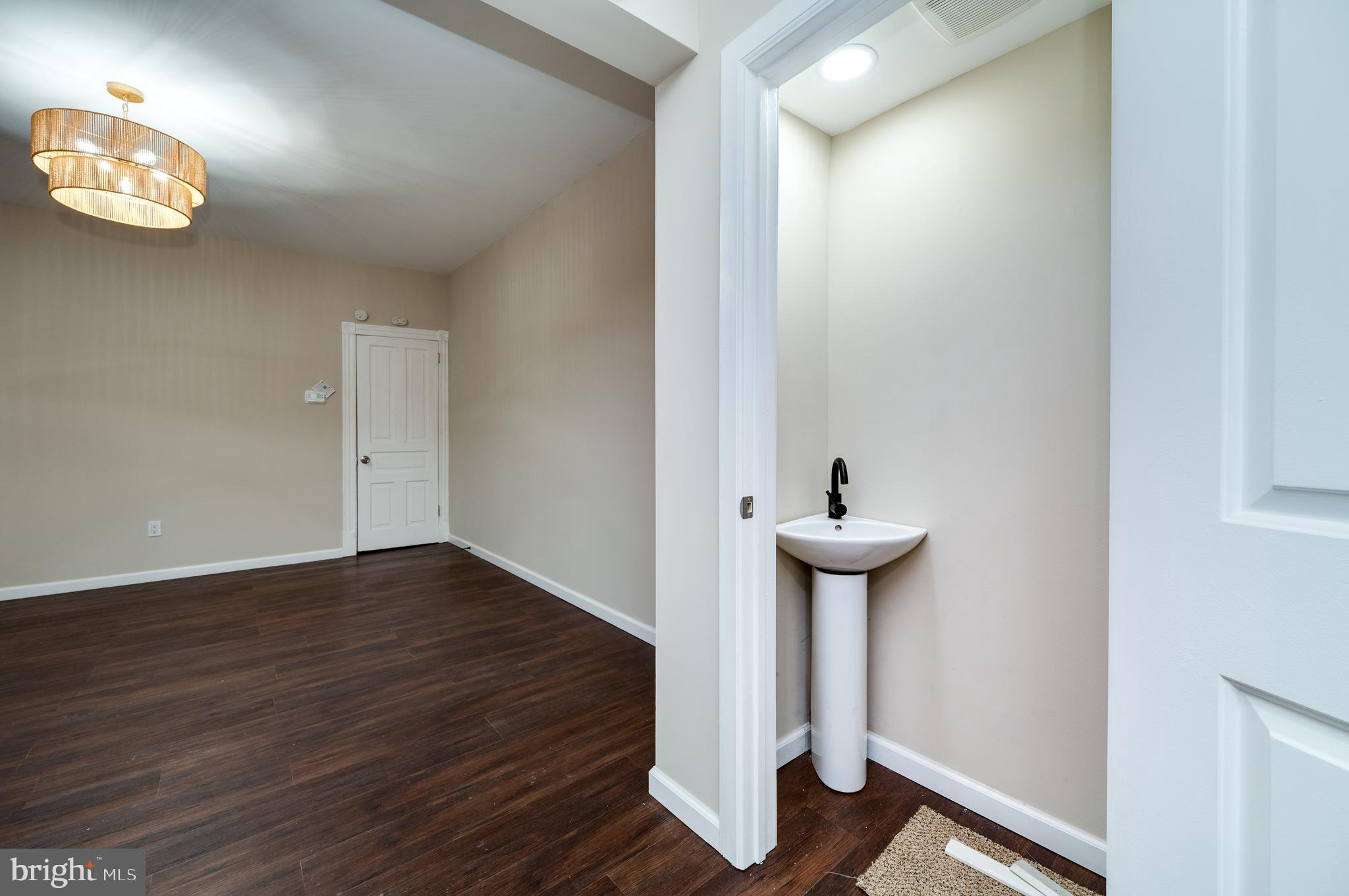 137 Elm Street Reading, PA 19601 - Photo 14 of 49 a view of a hallway with wooden floor and a table