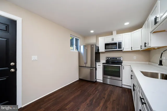 a kitchen with stainless steel appliances a refrigerator sink and cabinets
