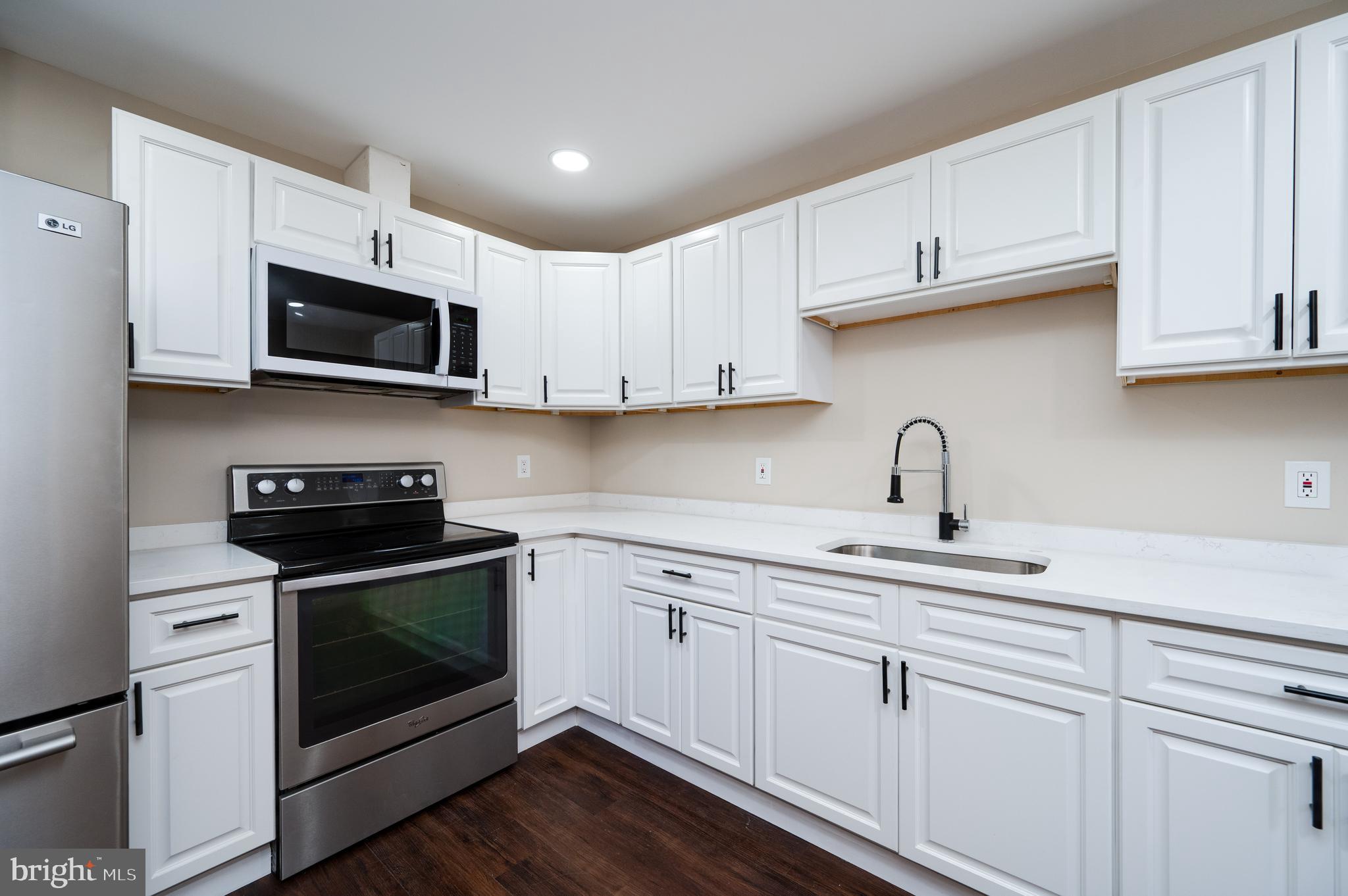 137 Elm Street Reading, PA 19601 - Photo 21 of 49 a kitchen with stainless steel appliances granite countertop grey cabinets a stove a sink and dishwasher